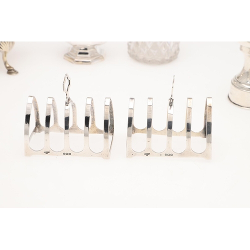 158 - A SMALL MIXED LOT OF SILVER. to include a pair of toast racks, an inkwell (loaded base), a sauce boa... 