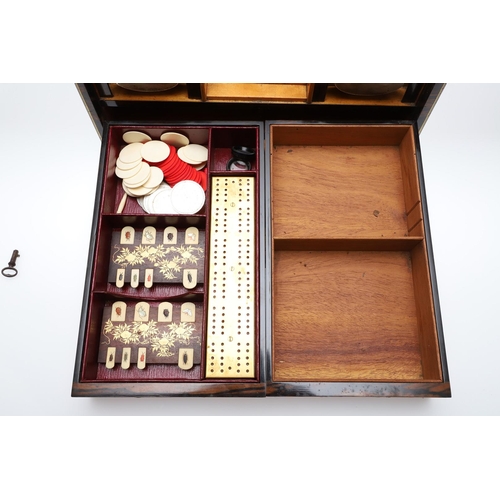 455 - A LATE 19TH CENTURY COROMANDEL AND BRASS BOUND GAMES TANTALUS. the satinwood veneered interior conta... 