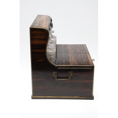 455 - A LATE 19TH CENTURY COROMANDEL AND BRASS BOUND GAMES TANTALUS. the satinwood veneered interior conta... 