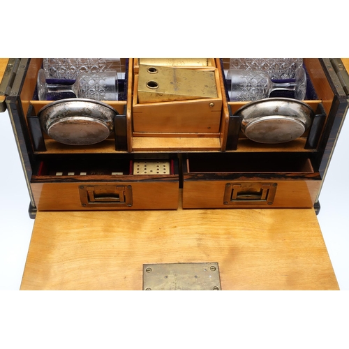 455 - A LATE 19TH CENTURY COROMANDEL AND BRASS BOUND GAMES TANTALUS. the satinwood veneered interior conta... 