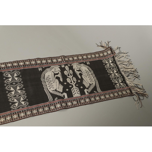 461 - AN INDONESIAN IKAT BODY ARMOUR TEXTILE. of exceptionally long length, depicting cream embroidered fi... 