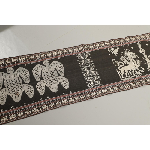 461 - AN INDONESIAN IKAT BODY ARMOUR TEXTILE. of exceptionally long length, depicting cream embroidered fi... 