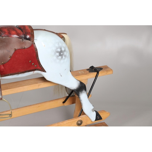 469 - A STEVENSON BROTHERS DAPPLE GREY ROCKING HORSE. with burgundy leather tack on a beech frame, with ma... 