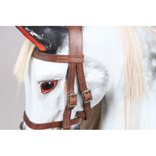 469 - A STEVENSON BROTHERS DAPPLE GREY ROCKING HORSE. with burgundy leather tack on a beech frame, with ma... 