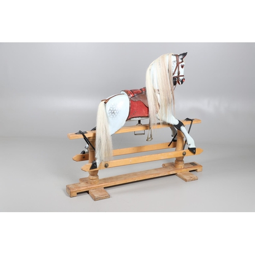 469 - A STEVENSON BROTHERS DAPPLE GREY ROCKING HORSE. with burgundy leather tack on a beech frame, with ma... 