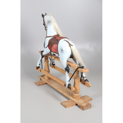 469 - A STEVENSON BROTHERS DAPPLE GREY ROCKING HORSE. with burgundy leather tack on a beech frame, with ma... 