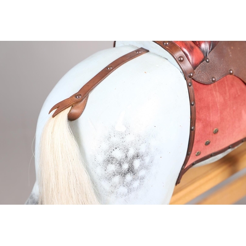 469 - A STEVENSON BROTHERS DAPPLE GREY ROCKING HORSE. with burgundy leather tack on a beech frame, with ma... 