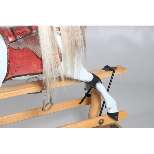 469 - A STEVENSON BROTHERS DAPPLE GREY ROCKING HORSE. with burgundy leather tack on a beech frame, with ma... 