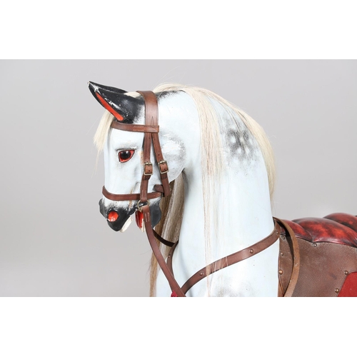 469 - A STEVENSON BROTHERS DAPPLE GREY ROCKING HORSE. with burgundy leather tack on a beech frame, with ma... 