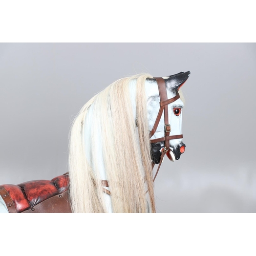 469 - A STEVENSON BROTHERS DAPPLE GREY ROCKING HORSE. with burgundy leather tack on a beech frame, with ma... 