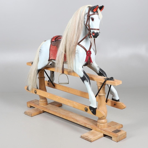 469 - A STEVENSON BROTHERS DAPPLE GREY ROCKING HORSE. with burgundy leather tack on a beech frame, with ma... 