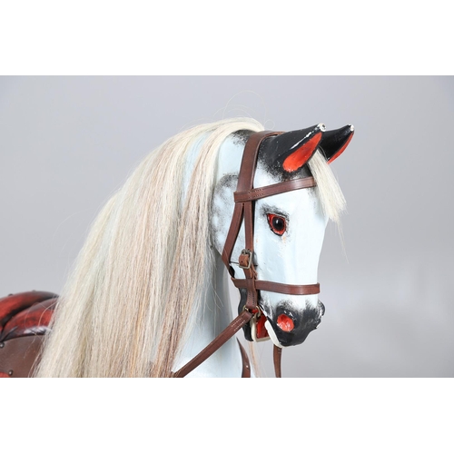 469 - A STEVENSON BROTHERS DAPPLE GREY ROCKING HORSE. with burgundy leather tack on a beech frame, with ma... 