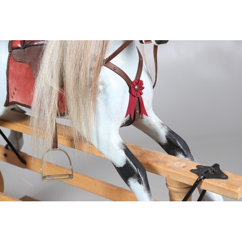 469 - A STEVENSON BROTHERS DAPPLE GREY ROCKING HORSE. with burgundy leather tack on a beech frame, with ma... 