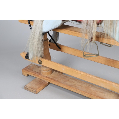 469 - A STEVENSON BROTHERS DAPPLE GREY ROCKING HORSE. with burgundy leather tack on a beech frame, with ma... 