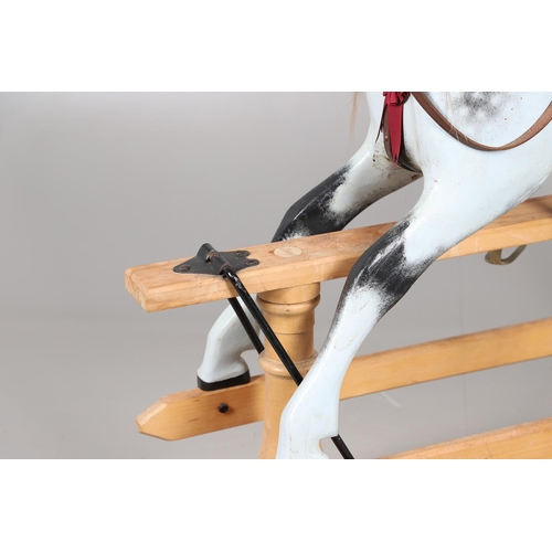 469 - A STEVENSON BROTHERS DAPPLE GREY ROCKING HORSE. with burgundy leather tack on a beech frame, with ma... 