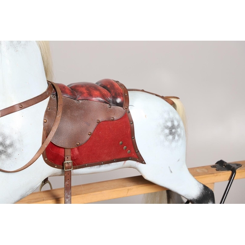 469 - A STEVENSON BROTHERS DAPPLE GREY ROCKING HORSE. with burgundy leather tack on a beech frame, with ma... 