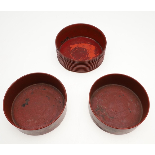 470 - A PAIR OF REGENCY RED LACQUERED WINE COASTERS. with foliage decoration in gilt, 4.5cm high, 13.5cm d... 