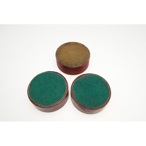 470 - A PAIR OF REGENCY RED LACQUERED WINE COASTERS. with foliage decoration in gilt, 4.5cm high, 13.5cm d... 