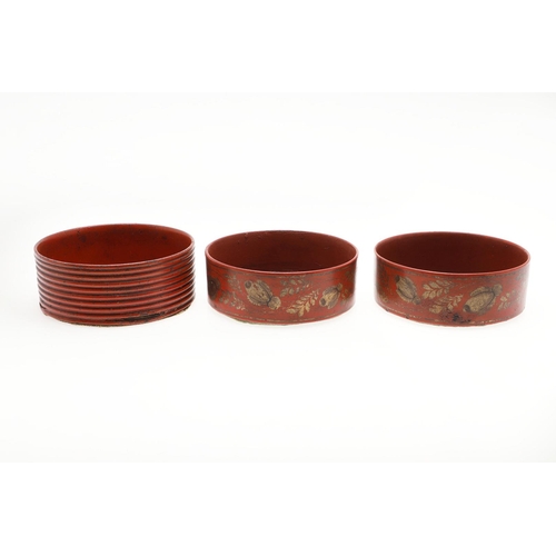 470 - A PAIR OF REGENCY RED LACQUERED WINE COASTERS. with foliage decoration in gilt, 4.5cm high, 13.5cm d... 