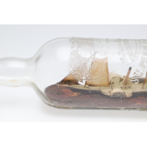 473 - A FOLK ART PADDLE STEAMER IN BOTTLE. on a painted naturalistic sea, bottle length 47cm.   *CR  No re... 