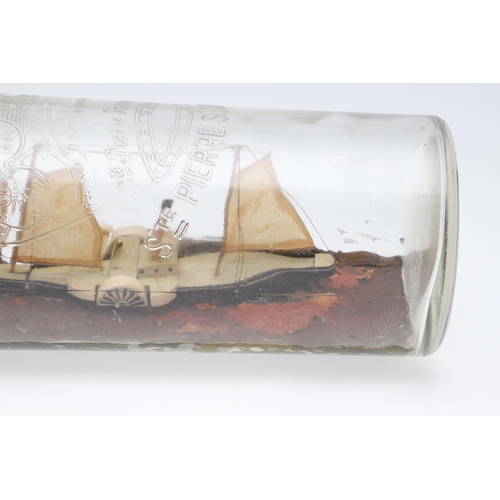 473 - A FOLK ART PADDLE STEAMER IN BOTTLE. on a painted naturalistic sea, bottle length 47cm.   *CR  No re... 