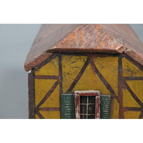 475 - A FOLK ART POLYCHROME PAINTED DOG KENNEL. circa 1900, in the form of a brick and cob barn with appli... 