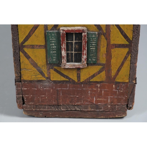 475 - A FOLK ART POLYCHROME PAINTED DOG KENNEL. circa 1900, in the form of a brick and cob barn with appli... 