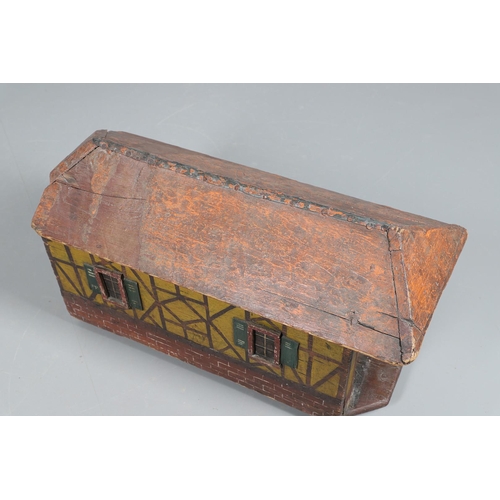 475 - A FOLK ART POLYCHROME PAINTED DOG KENNEL. circa 1900, in the form of a brick and cob barn with appli... 