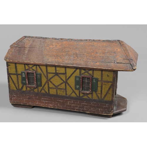 475 - A FOLK ART POLYCHROME PAINTED DOG KENNEL. circa 1900, in the form of a brick and cob barn with appli... 