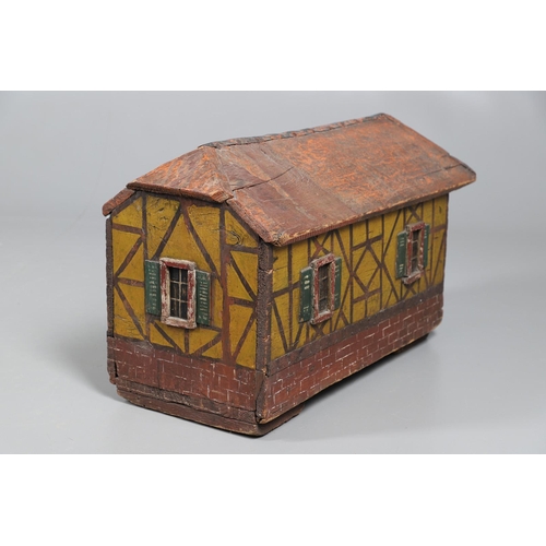 475 - A FOLK ART POLYCHROME PAINTED DOG KENNEL. circa 1900, in the form of a brick and cob barn with appli... 