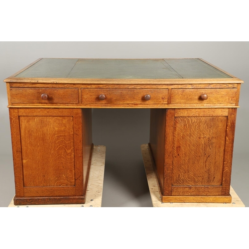 483 - A LATE 19TH CENTURY OAK PARTNERS DESK. the top inset with gilt tooled green leather over an arrangem... 