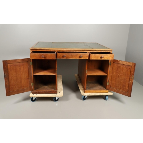 483 - A LATE 19TH CENTURY OAK PARTNERS DESK. the top inset with gilt tooled green leather over an arrangem... 