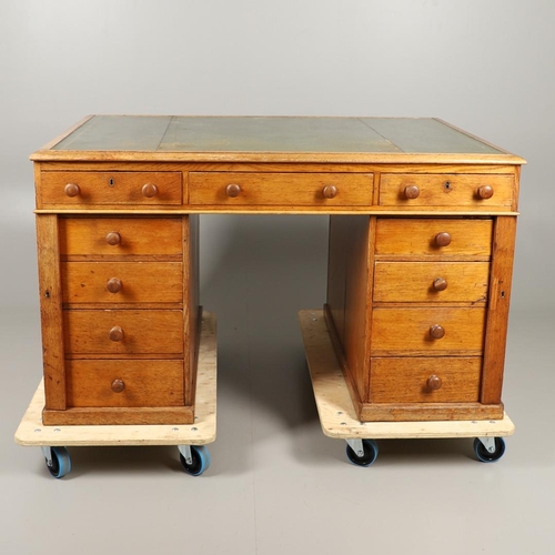 483 - A LATE 19TH CENTURY OAK PARTNERS DESK. the top inset with gilt tooled green leather over an arrangem... 