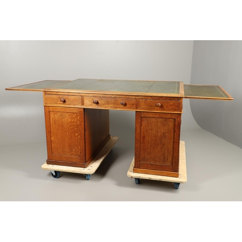 483 - A LATE 19TH CENTURY OAK PARTNERS DESK. the top inset with gilt tooled green leather over an arrangem... 