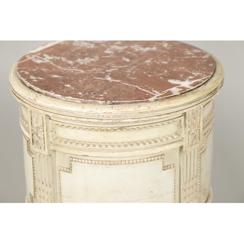 495 - A PAIR OF FRENCH MARBLE TOP PAINTED POT CUPBOARDS. of cylindrical form with moulded Classical motif ... 