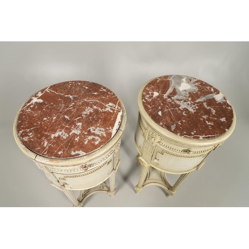 495 - A PAIR OF FRENCH MARBLE TOP PAINTED POT CUPBOARDS. of cylindrical form with moulded Classical motif ... 