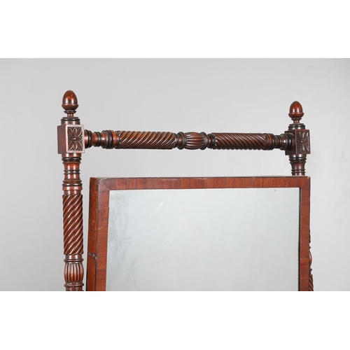 503 - A REGENCY MAHOGANY CHEVAL MIRROR. the frame with turned spiral and flower head detail and acorn fini... 