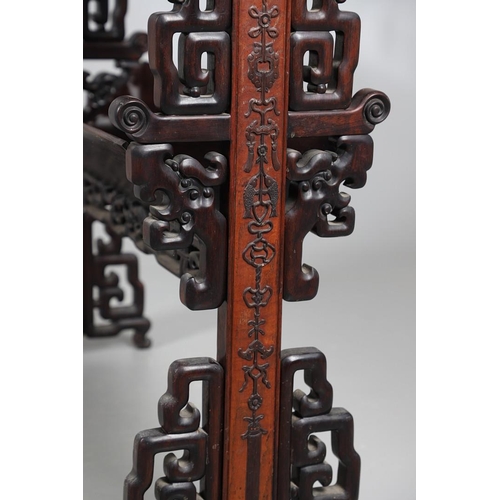 506 - AN EARLY 20TH CENTURY CHINESE HARDWOOD BOOK TROUGH. the ends carved with dragon's heads and low reli... 