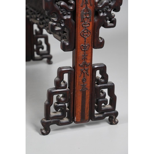 506 - AN EARLY 20TH CENTURY CHINESE HARDWOOD BOOK TROUGH. the ends carved with dragon's heads and low reli... 