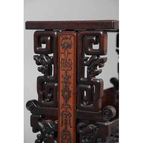 506 - AN EARLY 20TH CENTURY CHINESE HARDWOOD BOOK TROUGH. the ends carved with dragon's heads and low reli... 