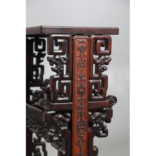 506 - AN EARLY 20TH CENTURY CHINESE HARDWOOD BOOK TROUGH. the ends carved with dragon's heads and low reli... 