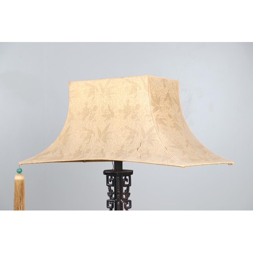 507 - AN EARLY 20TH CENTURY CHINESE HARDWOOD STANDARD LAMP. the ends carved with foliate and cloud detail,... 