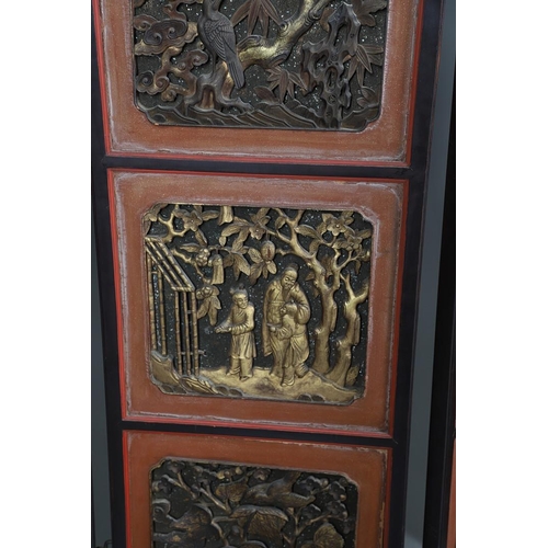 509 - A CHINESE CARVED AND LACQUERED SIX FOLD SCREEN. early 20th century, each red and black lacquered pan... 