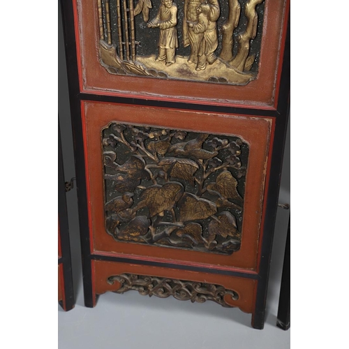 509 - A CHINESE CARVED AND LACQUERED SIX FOLD SCREEN. early 20th century, each red and black lacquered pan... 