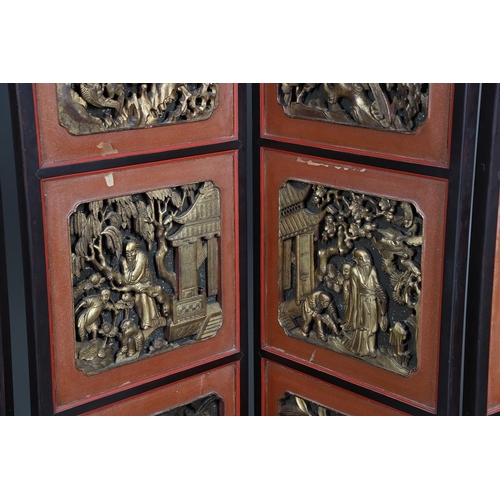 509 - A CHINESE CARVED AND LACQUERED SIX FOLD SCREEN. early 20th century, each red and black lacquered pan... 