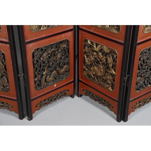 509 - A CHINESE CARVED AND LACQUERED SIX FOLD SCREEN. early 20th century, each red and black lacquered pan... 