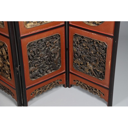 509 - A CHINESE CARVED AND LACQUERED SIX FOLD SCREEN. early 20th century, each red and black lacquered pan... 