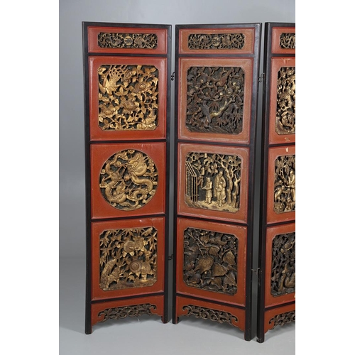 509 - A CHINESE CARVED AND LACQUERED SIX FOLD SCREEN. early 20th century, each red and black lacquered pan... 