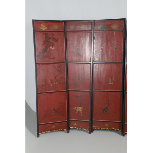 509 - A CHINESE CARVED AND LACQUERED SIX FOLD SCREEN. early 20th century, each red and black lacquered pan... 