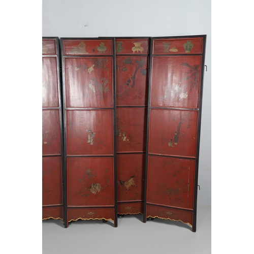 509 - A CHINESE CARVED AND LACQUERED SIX FOLD SCREEN. early 20th century, each red and black lacquered pan... 